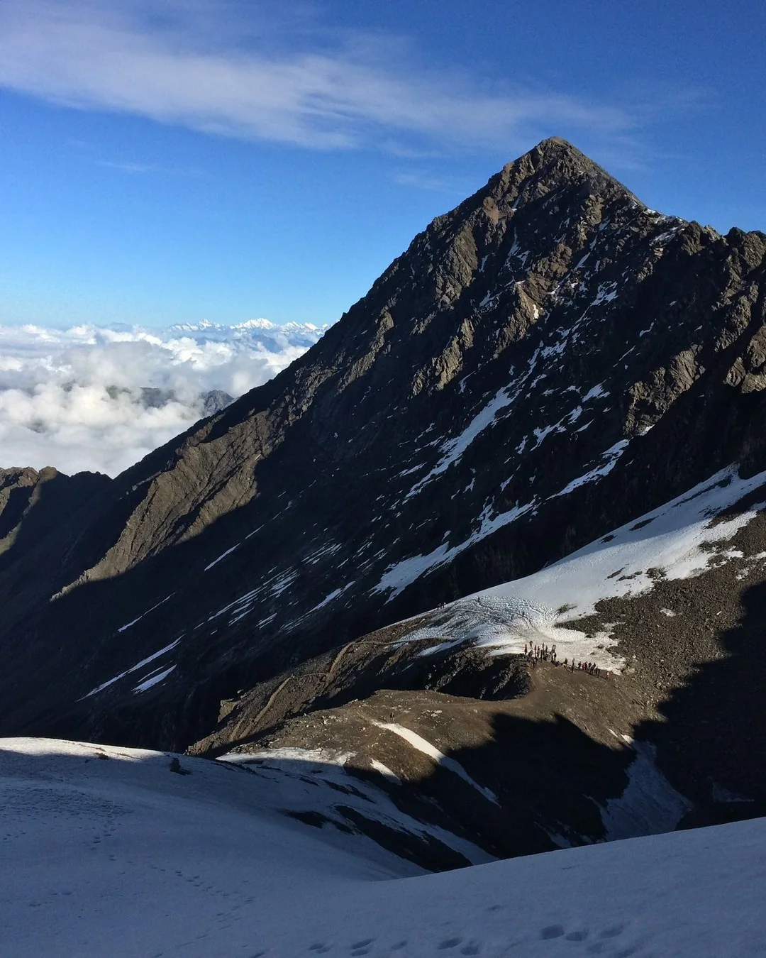 Snow peak above the clouds from Junargali