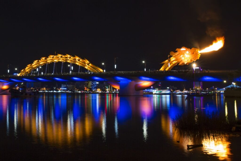 Marvel at the dazzling Dragon Bridge and its fire-breathing show